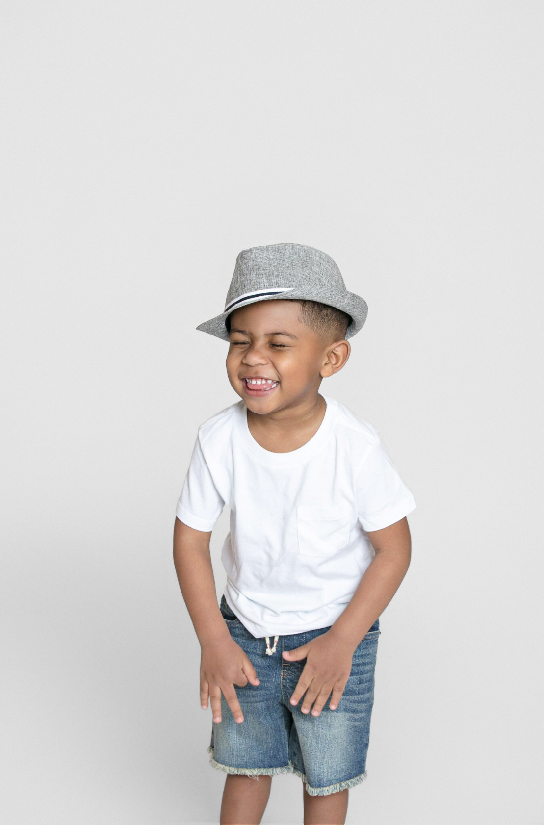 Laughing boy in a gray hat